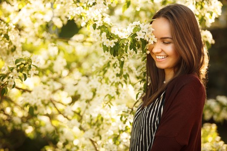 lovely woman with a blooming tree street.の写真素材