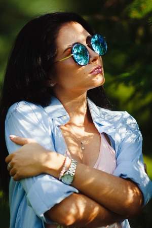 Vertical portrait of beautiful woman wears round sunglasses.の写真素材