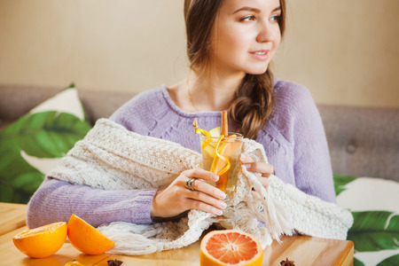 Girl looking on her left holding glass with fruitsの写真素材