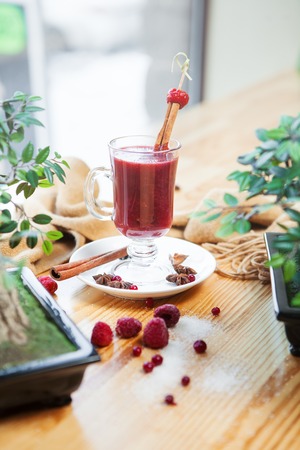 Closeup of hot mulled wine in glass with cinnamon sticksの写真素材