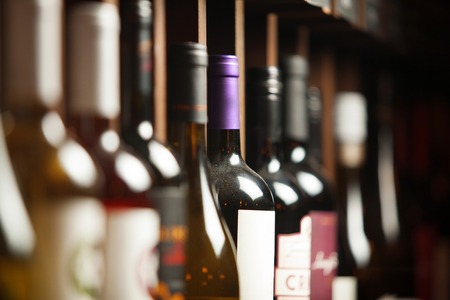 Wine cellar with elite drinks on shelves with written namesの写真素材