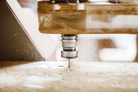 CNC milling machine. Machine tool in wood factory with drilling machines.