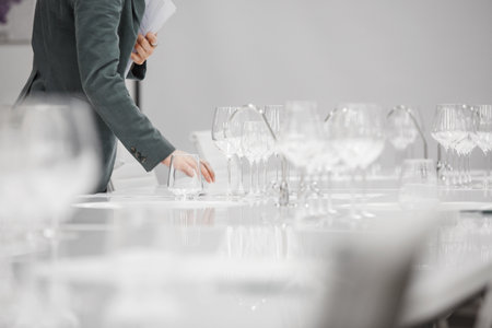 Layout of wine glasses on the table, preparing for the tasting of alcoholic beverages. Preparation to the blind wine tasting for beginners sommelier. Wine school, winemaking lecture.の写真素材