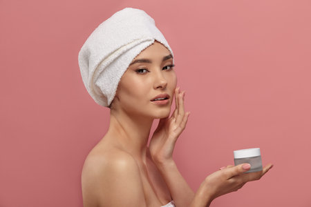 Female model demonstrates container for moisturizer.の写真素材