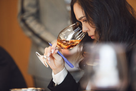 Professional Female Cavist Tasting Wine at Sommelier Association Eventの写真素材