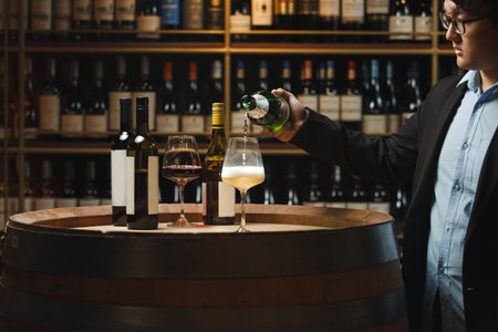 Sommelier Pouring Sparkling Wine in Cellarの写真素材