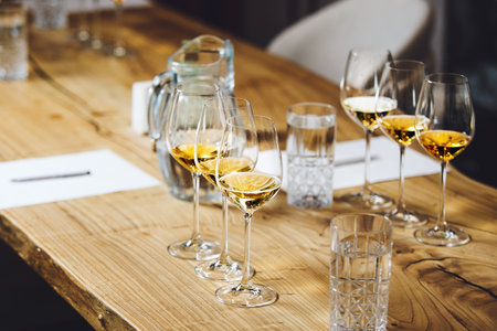 Wine tasting preparation. Various white wines in glasses without name. Blind degustation.の写真素材