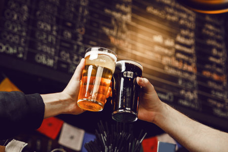 Friends Celebrating With Cheers While Raising Glasses of Beer in Festive Pub Atmosphere