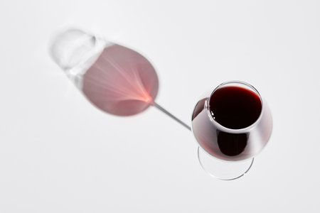 Red wine is in wineglass isolated on white background.の写真素材