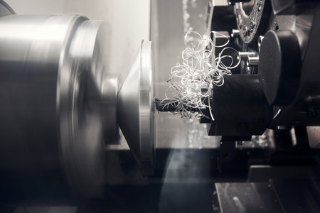CNC lathe machine chamfering cut the metal shape parts. The high technology metal working processing by CNC turning machine.の写真素材
