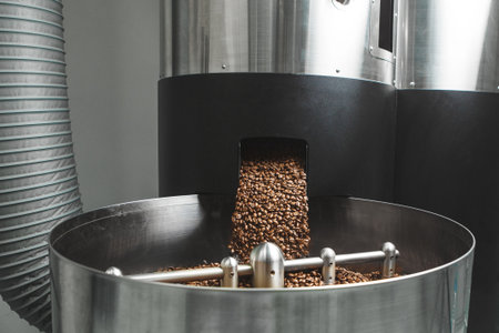 Roasted Coffee Beans Pouring Into Cooling Bin at Roasteryの写真素材