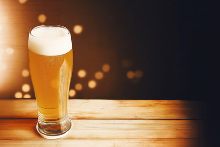 Tall glass of light beer with foamの素材