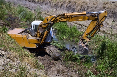 excavator along riverの写真素材