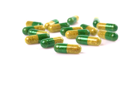 Green pills isolated over white. 