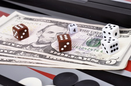 Dollar bills with dice on the   backgammon