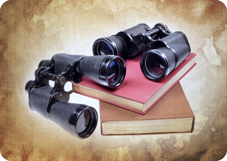 Vintage old  binoculars on ancient book . Nostalgic vintage backgroundの写真素材