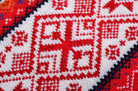 Macro red  knitting  fabric wool, material texture for background ,structure knitting 