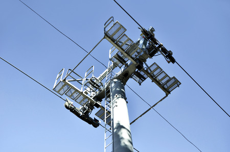 Top part of ski-lift support and few chairs on wiresの写真素材