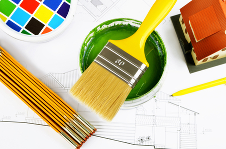 Paintbrush on cans with color prints,house model,
helmet with house project, top view. Concept.の写真素材