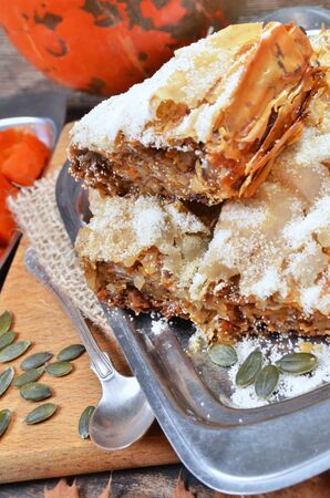 Traditional Turkish pastry ( kabak tatlisi ),baked in the oven orange pumpkin,pumpkin and walnut seeds.Selective focus.の写真素材