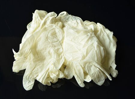 Coronavirus concept.Disposable white medical latex gloves on black background.Hygiene rules during the coronavirus epidemic. Healthcare equipment concept.の写真素材