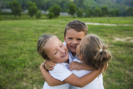 Happy kids. Emotions, hugs, real childhood friendship.の写真素材