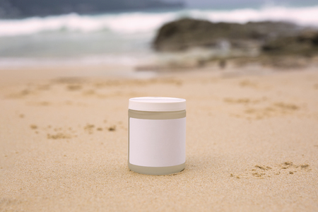 Bottle of sunblock on a sea backgroundの写真素材