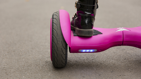 Child on hover board. Kids riding scooter in park. Balance board for children. Electric self...