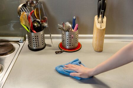 Cleaning kitchen with sponge, housework and housekeepingの写真素材