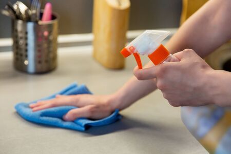 Cleaning kitchen with sponge, housework and housekeepingの写真素材
