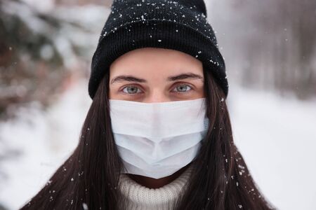 Alarmed female traveler wears medical mask to protect against coronavirus, afraid of infection. Deadly coronavirus in  2019 2020 2019-nCoVの写真素材