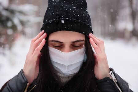 Alarmed female traveler wears medical mask to protect against coronavirus, afraid of infection. Deadly coronavirus in  2019 2020 2019-nCoVの写真素材