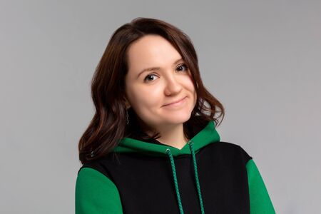 Woman in black and green hoodie, mockup for logo or branding design