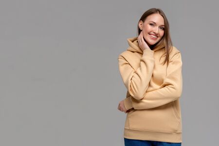 Woman in gold hoodie, mockup for logo or branding designの写真素材