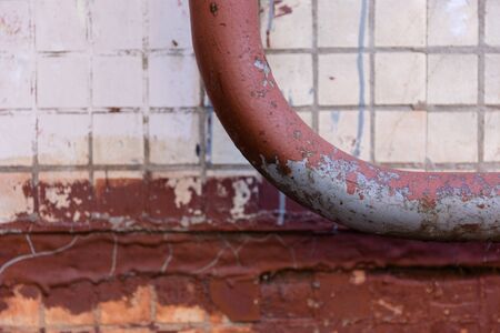 plumbing pipe against stucco wall , industrial grunge backgroundの写真素材