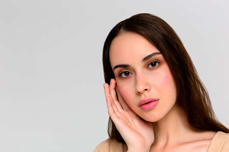 Beautiful Face of Young Woman with Clean Fresh Skin close up isolated on white. Beauty Portrait....