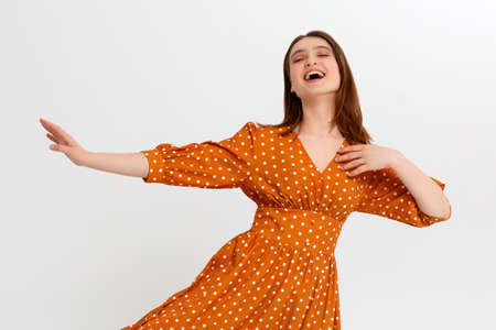 Beautiful fashion woman dancing - isolated over a white backgroundの写真素材