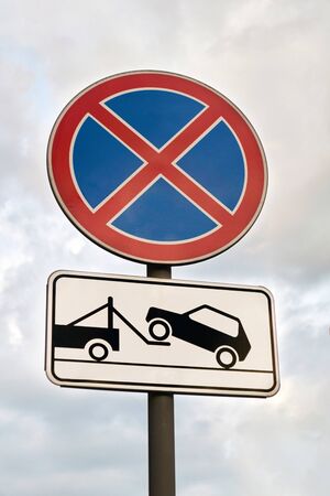 traffic signs stop is prohibited and the evacuation of cars against the skyの写真素材