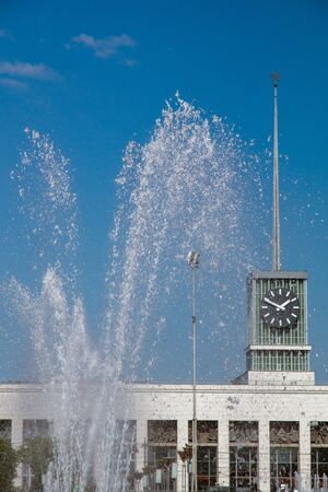 station building on the background of the fountain on a sunny summer dayの写真素材