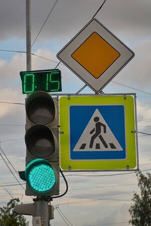 sign main road. pedestrian crossing sign. green traffic signal with timer
