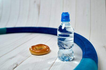 A bottle of water, crackers, drying on the background of boards for a healthy lifestyle.の写真素材