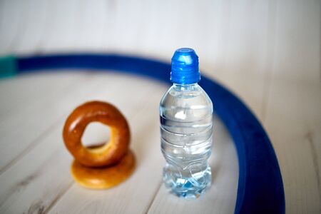 A bottle of water, crackers, drying on the background of boards for a healthy lifestyle.の写真素材