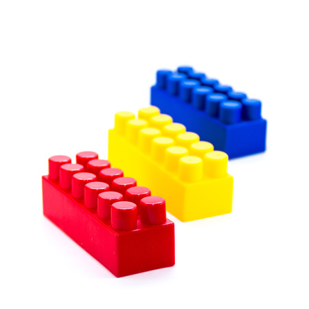 Colorful plastic toy blocks isolated on white background. Elements from the childrens designer.