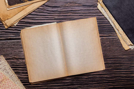 Vintage paper sheets, old checkered notebooks, retro design notepad on wooden backgroundの写真素材