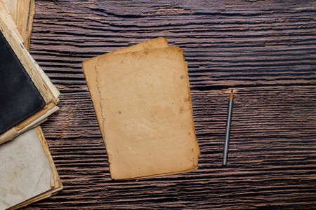Vintage paper sheets and old notebooks on wooden backgroundの写真素材