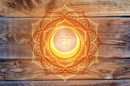 Svadhisthana chakra symbol on wooden  background. Artwork with mystical natural elements.の写真素材