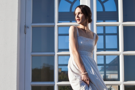 Beautiful woman in front of House Facadeの写真素材
