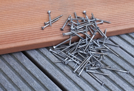 Pile of screws on a floorboardの写真素材