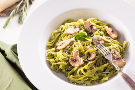 Tagliatelle pasta with pesto on white plateの写真素材
