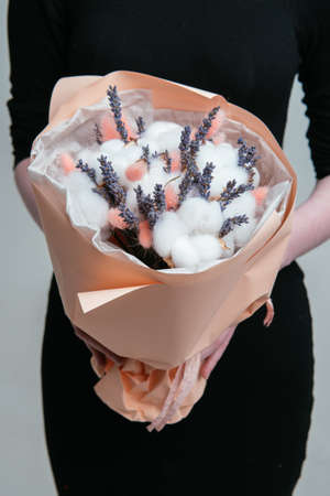 Composition of red, pink, transparent helium balloons and silver star in the hand of a woman on a white background.の写真素材